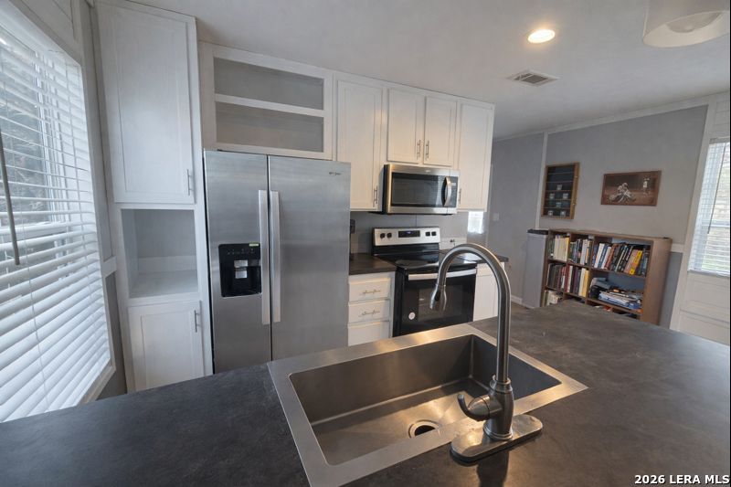 721 Tejas Trail Bandera, TX 78003 - Photo 6 of 17 a kitchen with kitchen island a counter top space cabinets and stainless steel appliances