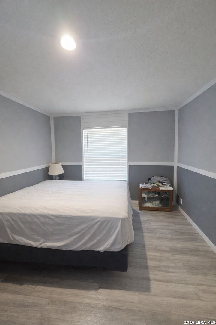 721 Tejas Trail Bandera, TX 78003 - Photo 8 of 17 a bedroom with a bed and a window