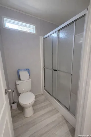 a bathroom with a toilet and a shower