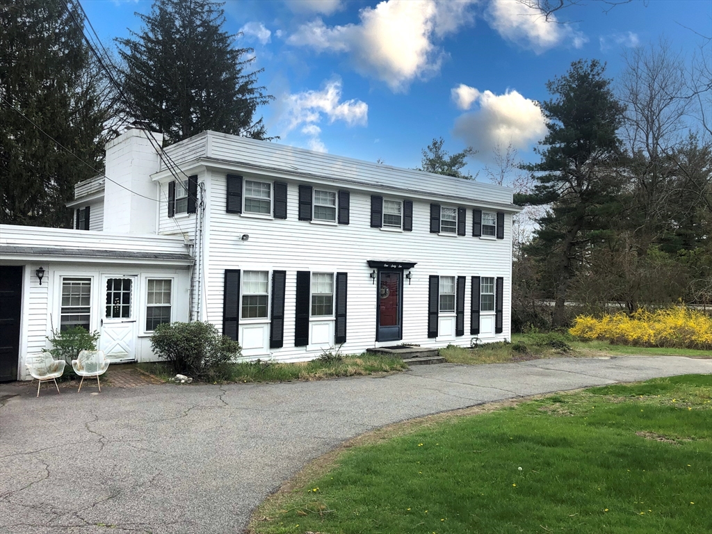166 Spring Street Lexington, MA 02421 - Photo 1 of 8 a front view of a house with a yard