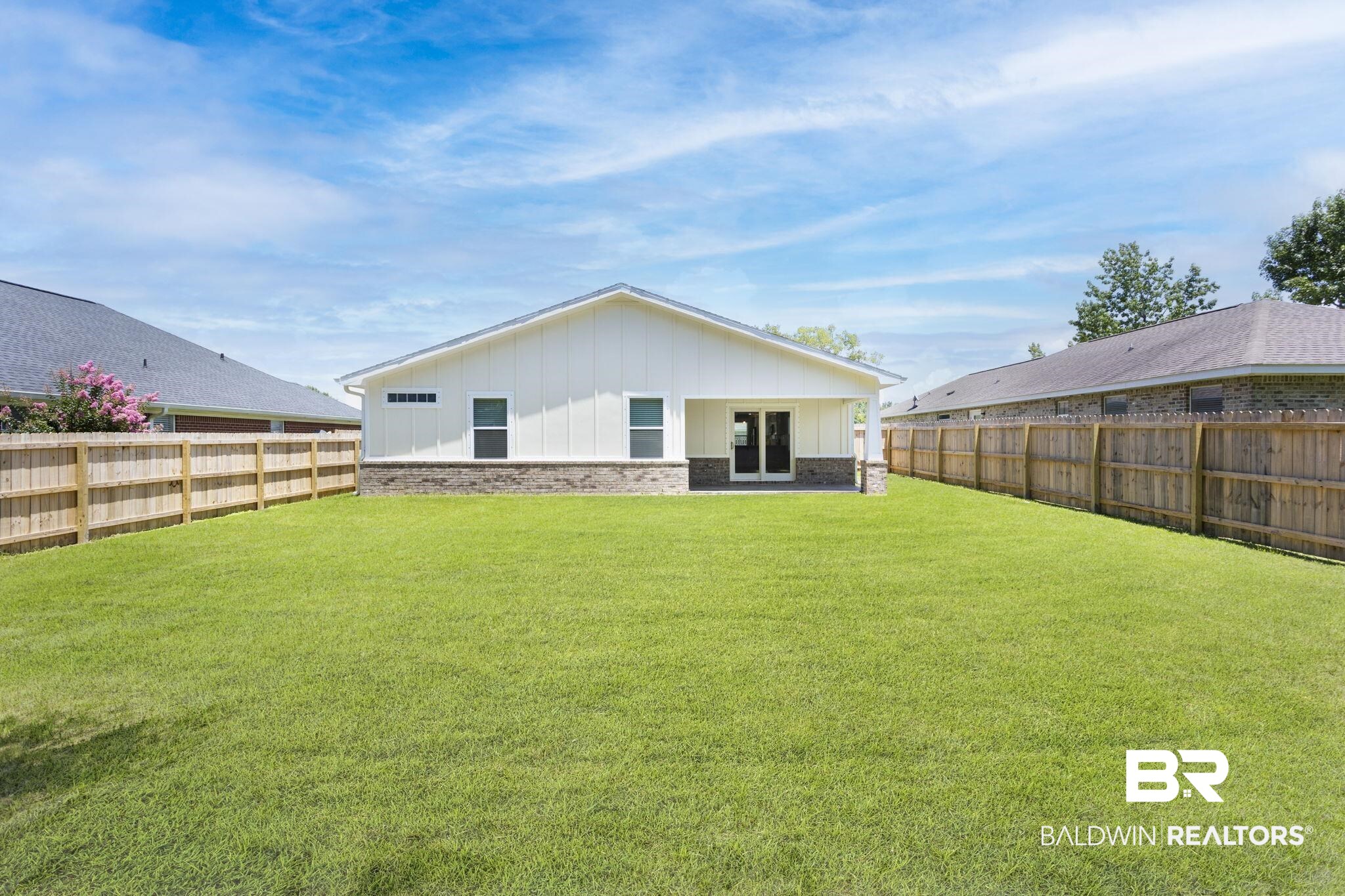 17126 Sugar Loop Foley, AL 36535 - Photo 24 of 28 Rear view of property with board and batten siding, a fenced backyard, and brick siding