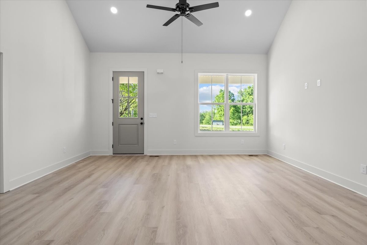 591 Fire Tower Road Dickson, TN 37055 - Photo 13 of 24 an empty room with window ceiling fan and wooden floor