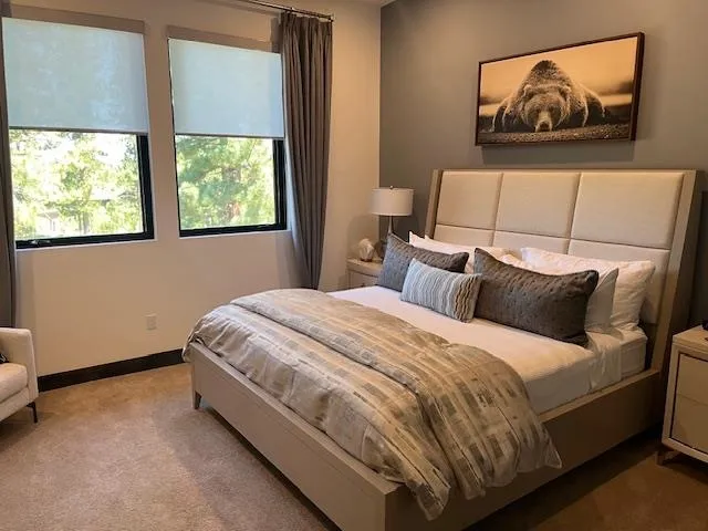 a bed sitting in a bedroom next to a window