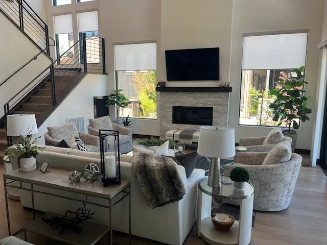 a living room with furniture a flat screen tv and a fireplace