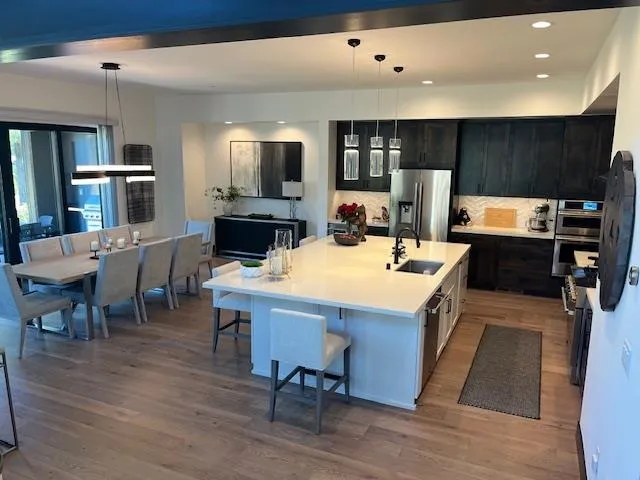 a view of a dining room with furniture and wooden floor
