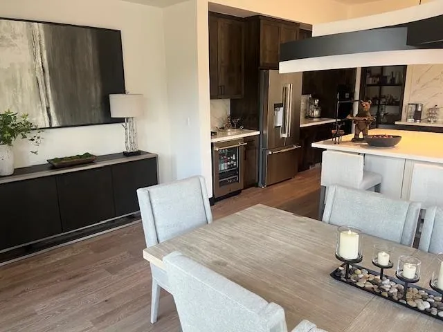 a kitchen with a table chairs and a refrigerator