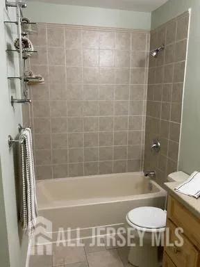 a bathroom with a sink a toilet and bathtub