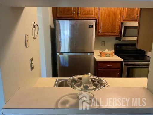 a kitchen with a refrigerator and a stove