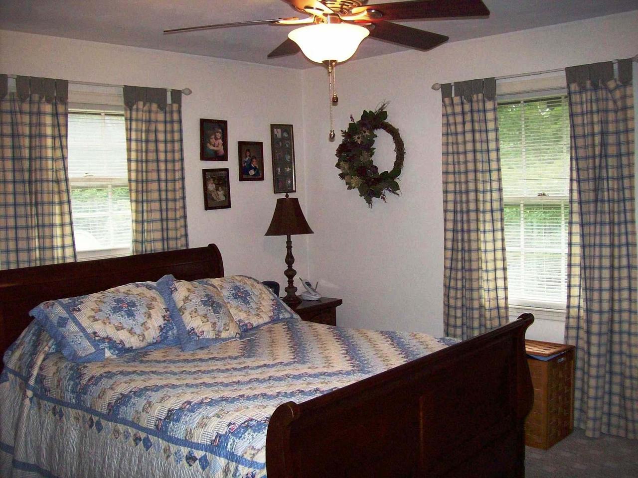 16 Persimmon Court Blue Ridge, VA 24064 - Photo 7 of 10 a bedroom with a bed and a chandelier