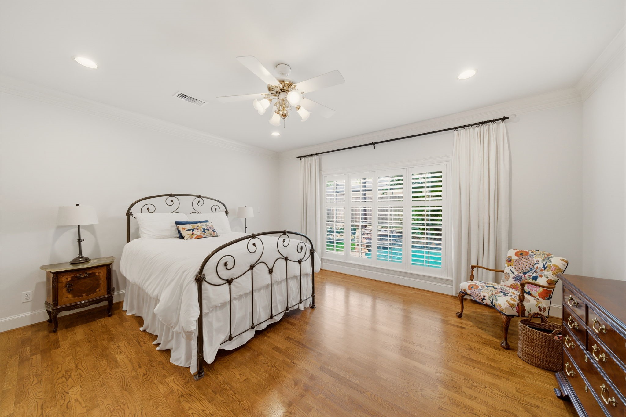 3 Martin Lane Spring Valley Village, TX 77055 - Photo 12 of 32 First floor Primary Suite with hardwood floors and views of the backyard and ppol area.