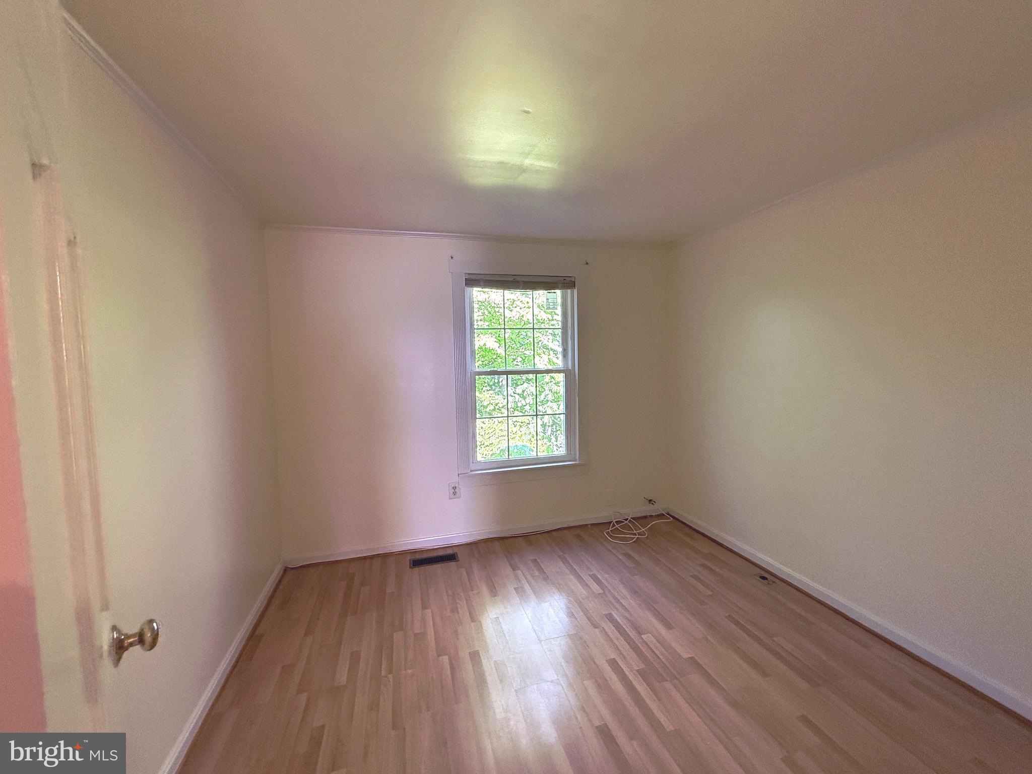 11 Wimbledon Court Silver Spring, MD 20906 - Photo 15 of 21 an empty room with wooden floor and windows