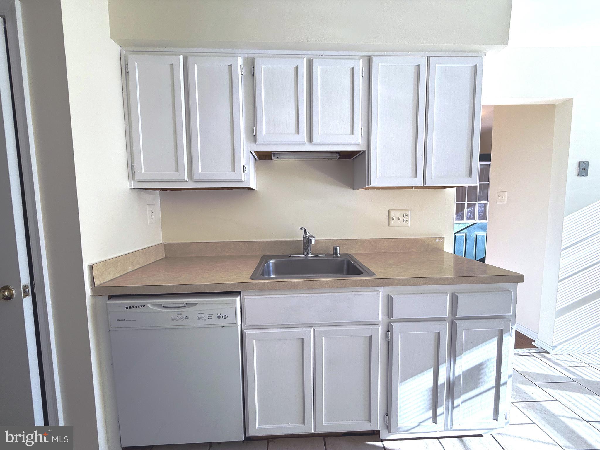 11 Wimbledon Court Silver Spring, MD 20906 - Photo 6 of 21 a kitchen with cabinets appliances a sink and a counter top space