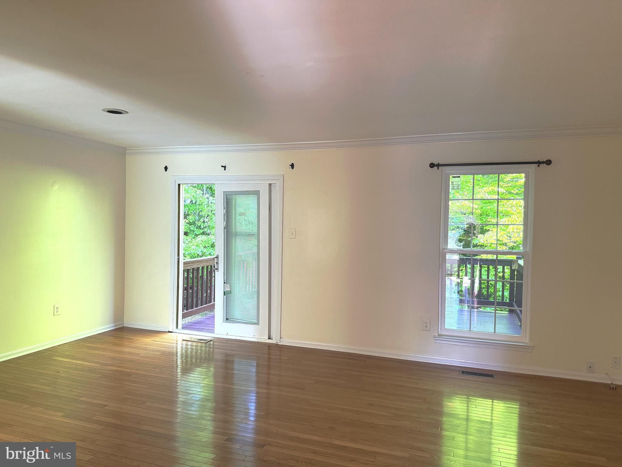11 Wimbledon Court Silver Spring, MD 20906 - Photo 7 of 21 a view of an empty room with wooden floor and a window