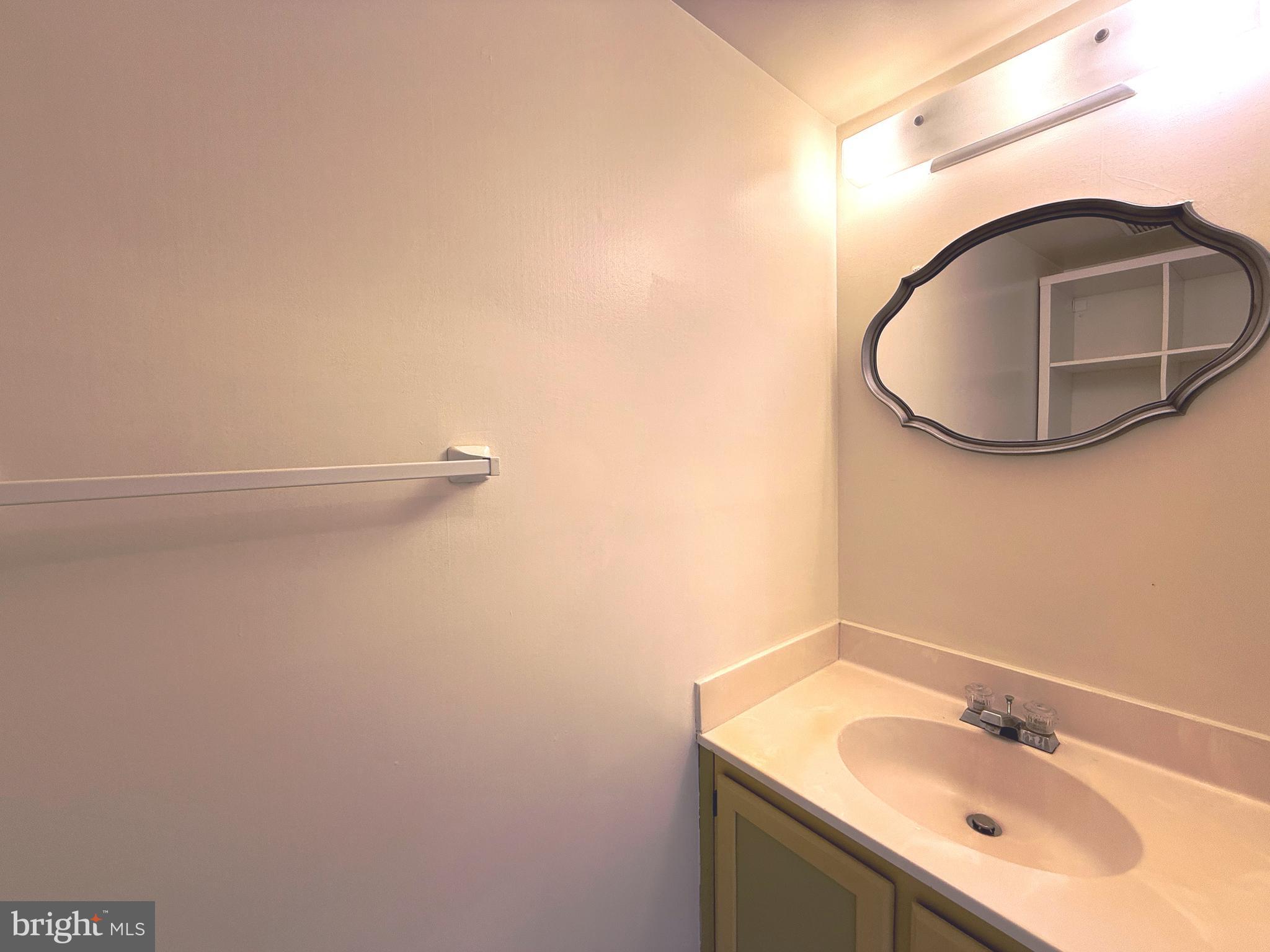 11 Wimbledon Court Silver Spring, MD 20906 - Photo 8 of 21 a bathroom with a sink and mirror