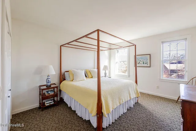 a bedroom with bed and a window