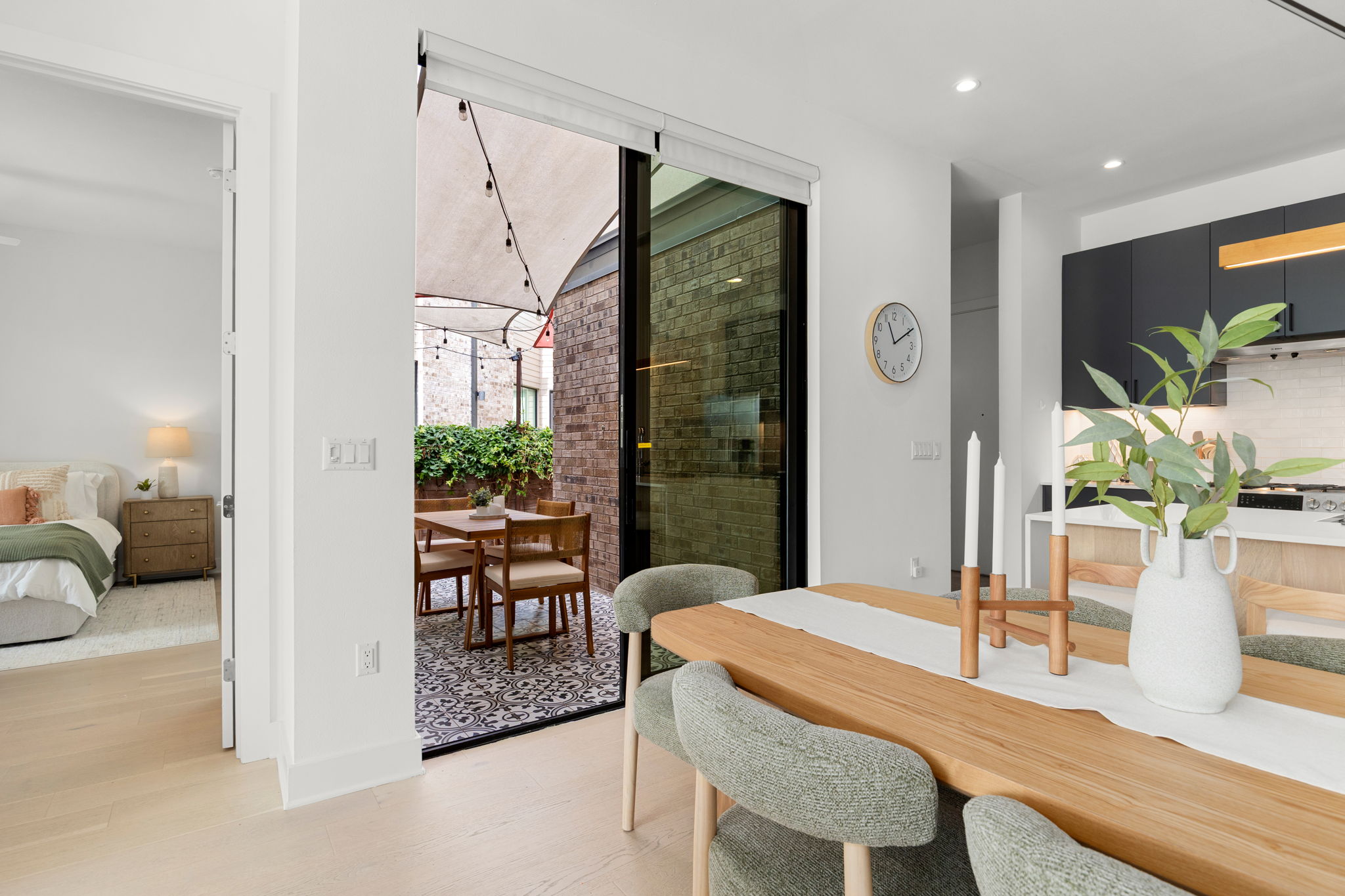 Sliding glass doors connect the bright dining area directly to a private tiled patio.
