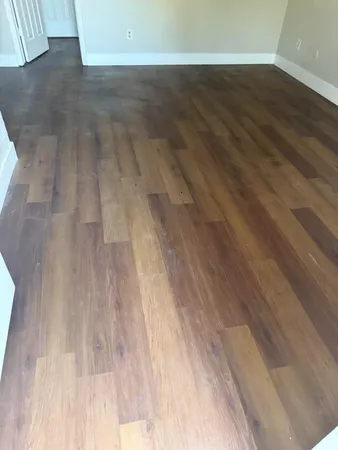 a view of a room with wooden floor