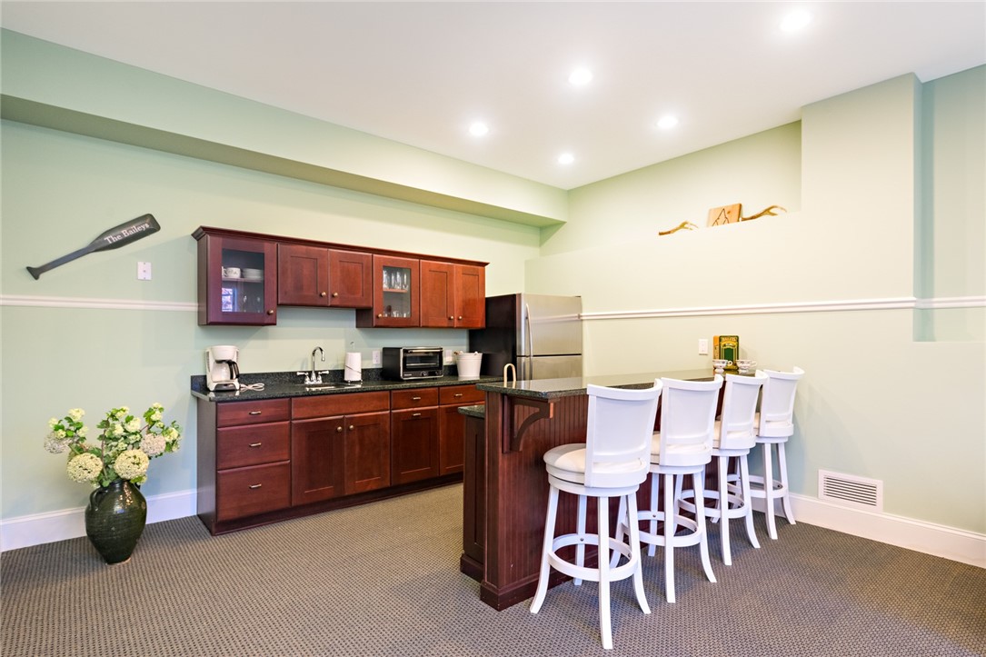 8 Kettle Cl Westerly, RI 02891 - Photo 27 of 39 Lower level bar area features a wet bar and cabinetry.