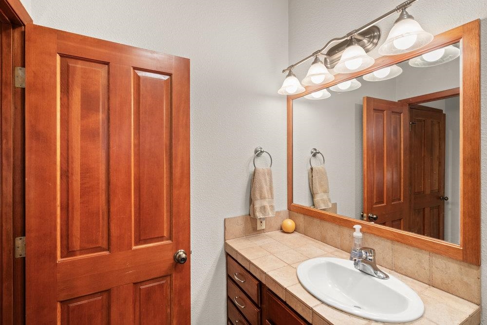 238 Clouds Rest Portola, CA 96122 - Photo 24 of 34 a bathroom with a sink vanity and a mirror