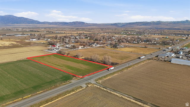 5601 West 15200 North Riverside, UT 84334 - Photo 4 of 10 Aerial view of sparsely populated area with property boundaries highlighted, mountains, and abundant farmland