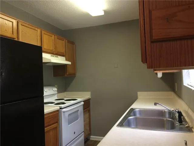 a kitchen with a sink and a refrigerator
