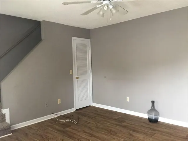 a view of an empty room with wooden floor