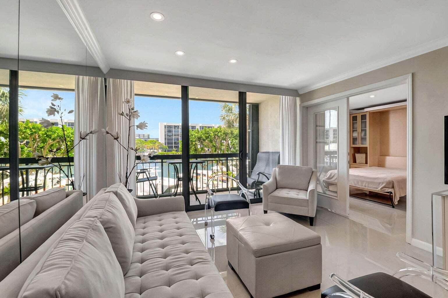 2707 North Ocean Boulevard, Unit D205 Boca Raton, FL 33431 - Photo 9 of 51 a living room with furniture and a large window