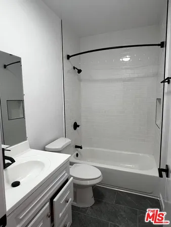 a bathroom with a sink a toilet and a bathtub