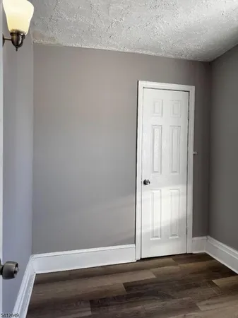 a kitchen with granite countertop a sink a stove and cabinets