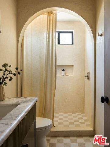 a view of a terrace with furniture and a garden