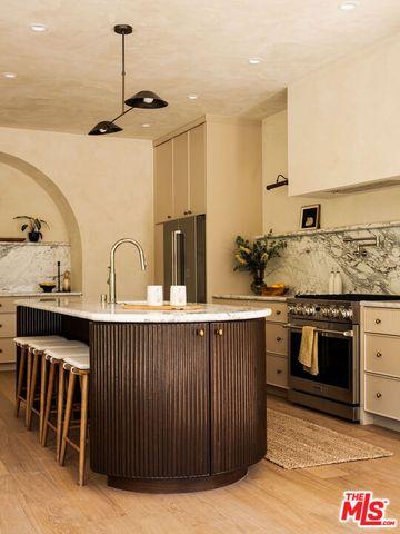 a kitchen with stainless steel appliances granite countertop a sink and stove top oven
