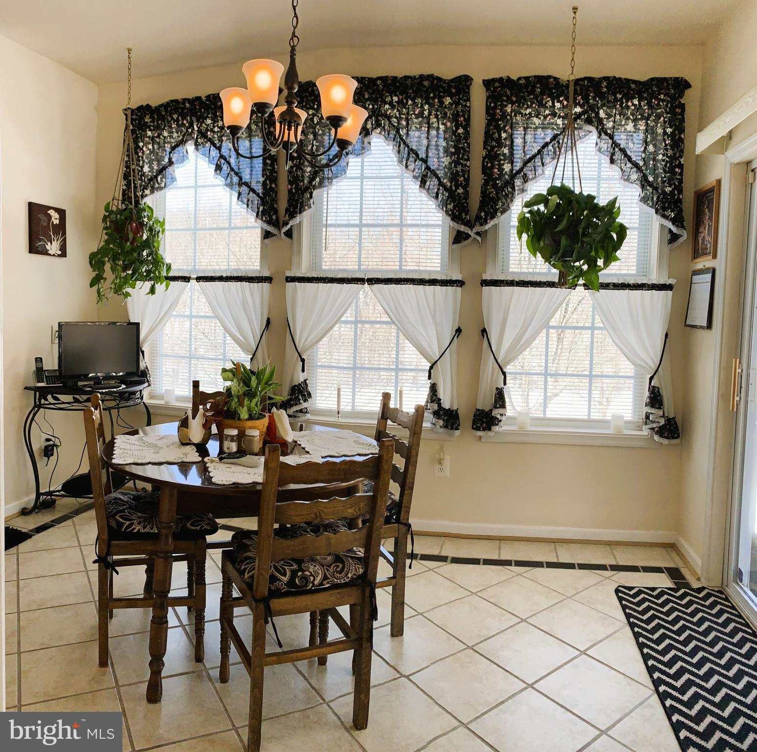 21112 Park Hall Road Boonsboro, MD 21713 - Photo 14 of 39 a view of a dining room with furniture and chandelier
