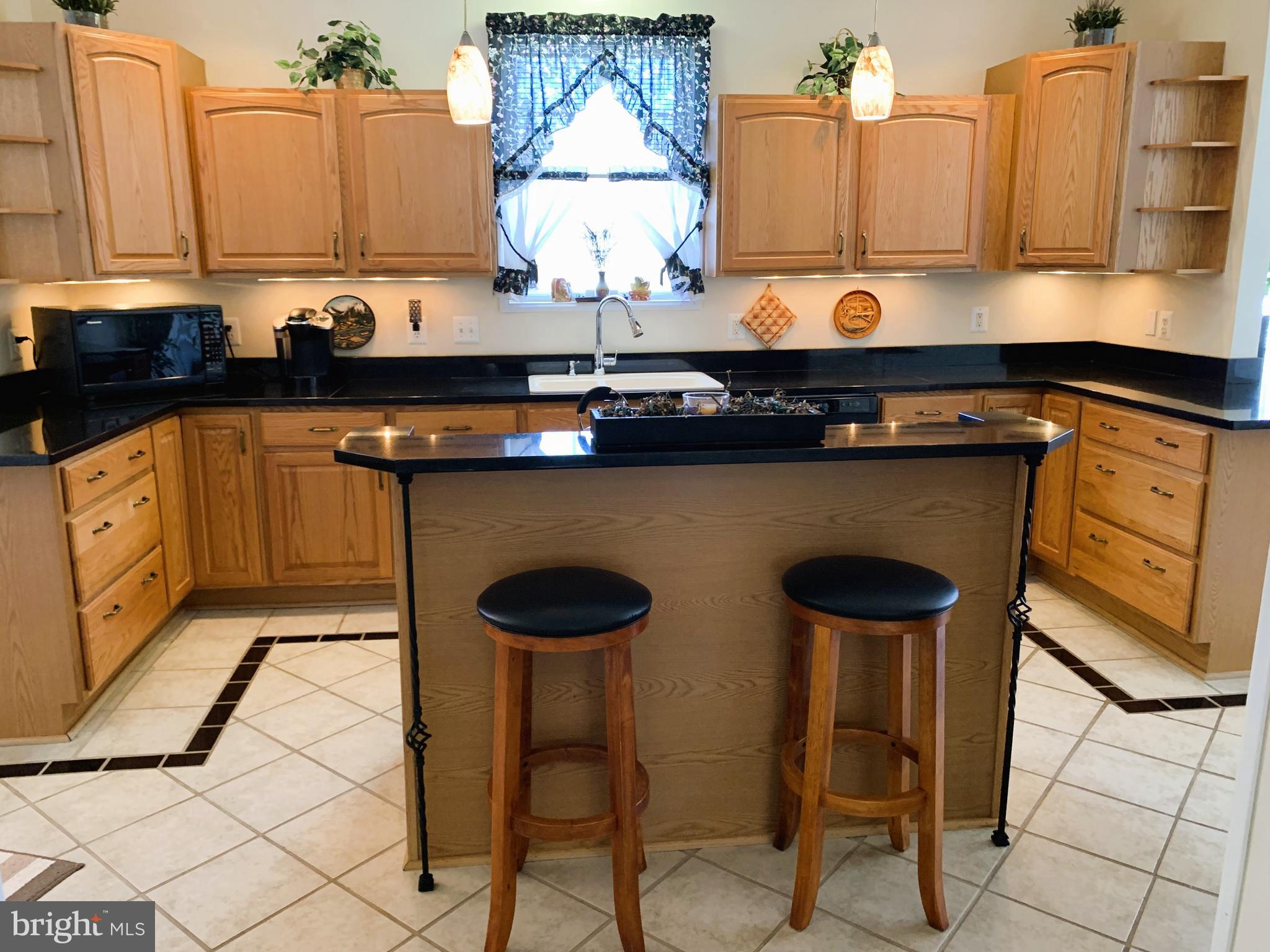 21112 Park Hall Road Boonsboro, MD 21713 - Photo 18 of 39 a kitchen with stainless steel appliances a stove a sink and a refrigerator