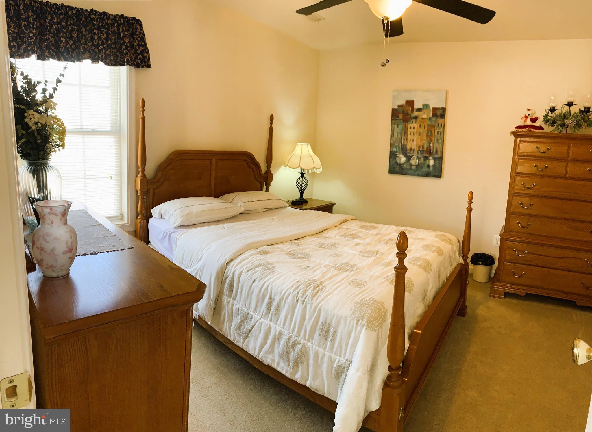 21112 Park Hall Road Boonsboro, MD 21713 - Photo 29 of 39 a bedroom with a bed and a chandelier fan