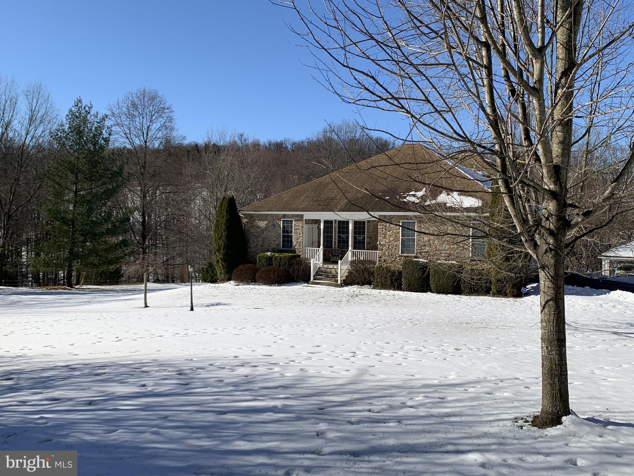 21112 Park Hall Road Boonsboro, MD 21713 - Photo 3 of 39 a front view of a house with a yard covered in snow