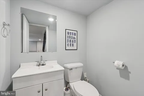 a view of a balcony with chairs and iron fence