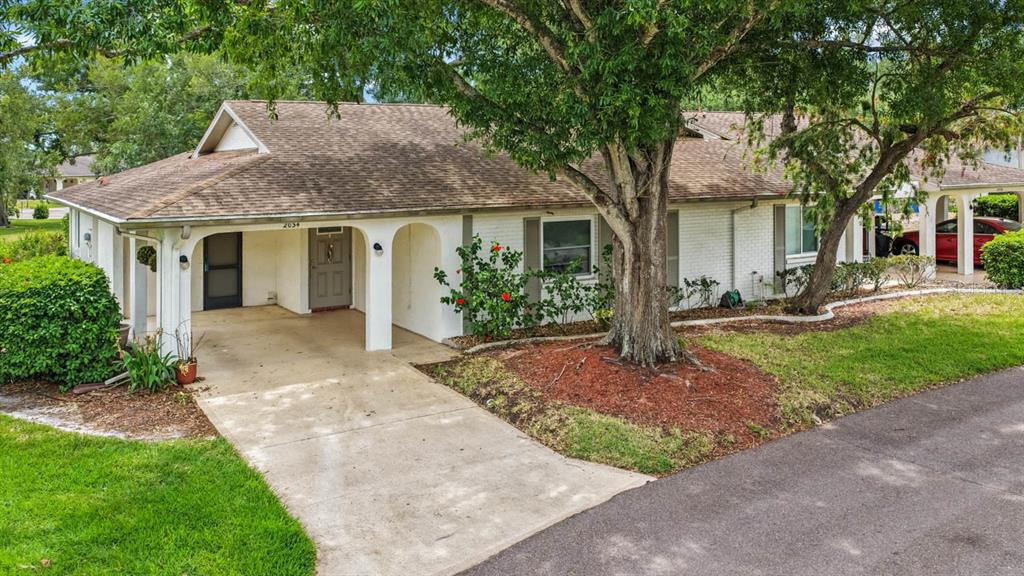 2034 Hawkhurst Circle, Unit 178 Sun City Center, FL 33573 - Photo 1 of 46 a front view of a house with garden