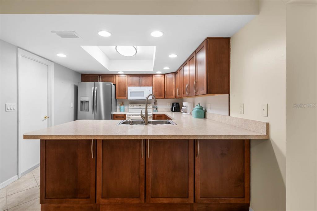 2034 Hawkhurst Circle, Unit 178 Sun City Center, FL 33573 - Photo 17 of 46 a kitchen with kitchen island granite countertop a sink and cabinets