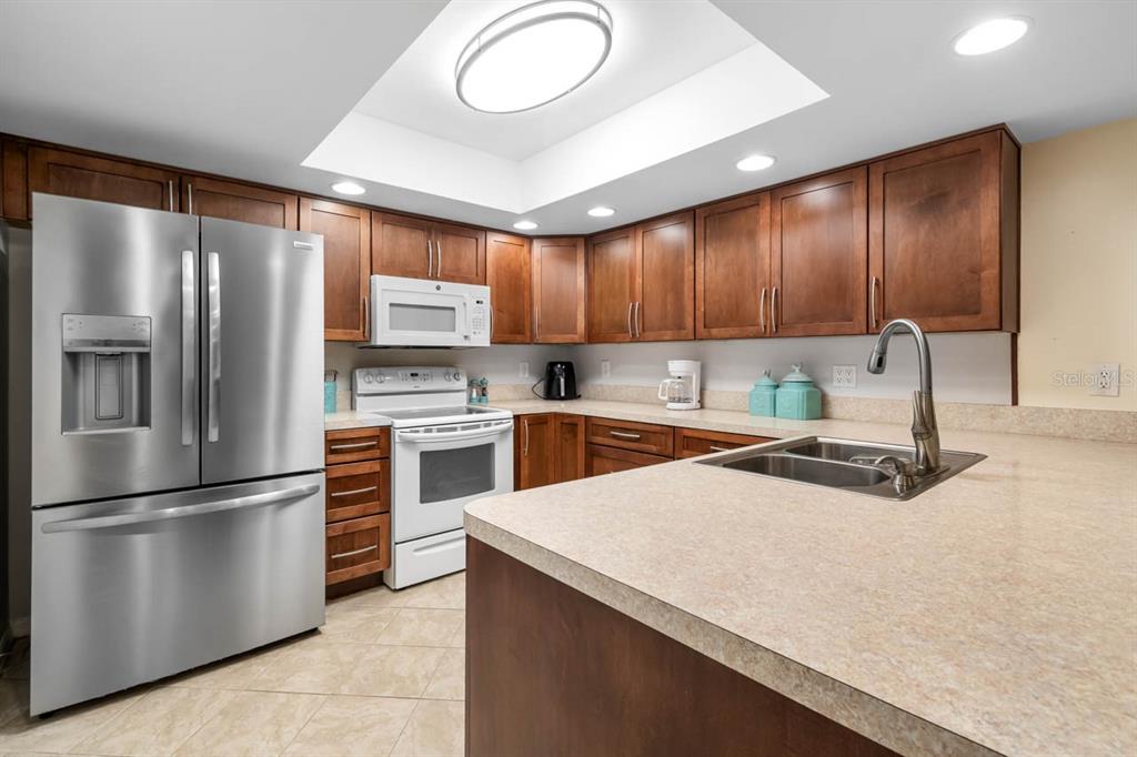 2034 Hawkhurst Circle, Unit 178 Sun City Center, FL 33573 - Photo 18 of 46 a kitchen with granite countertop stainless steel appliances and wooden cabinets