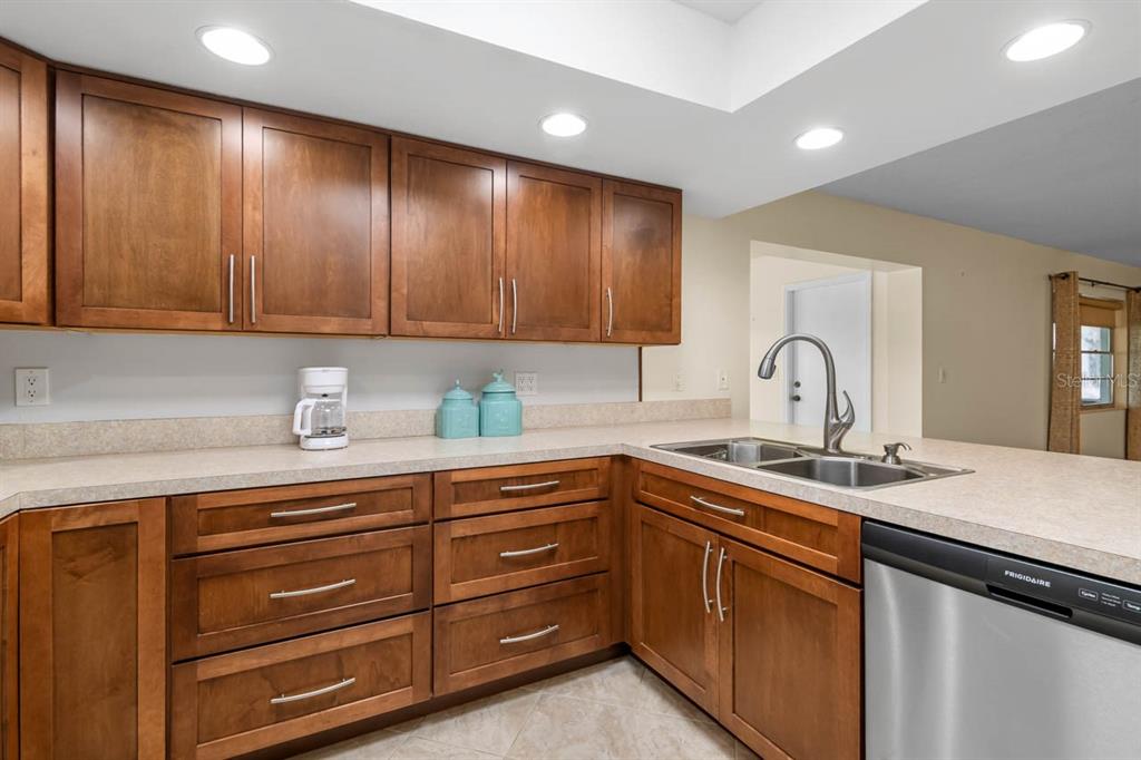 2034 Hawkhurst Circle, Unit 178 Sun City Center, FL 33573 - Photo 20 of 46 a kitchen with a sink and cabinets