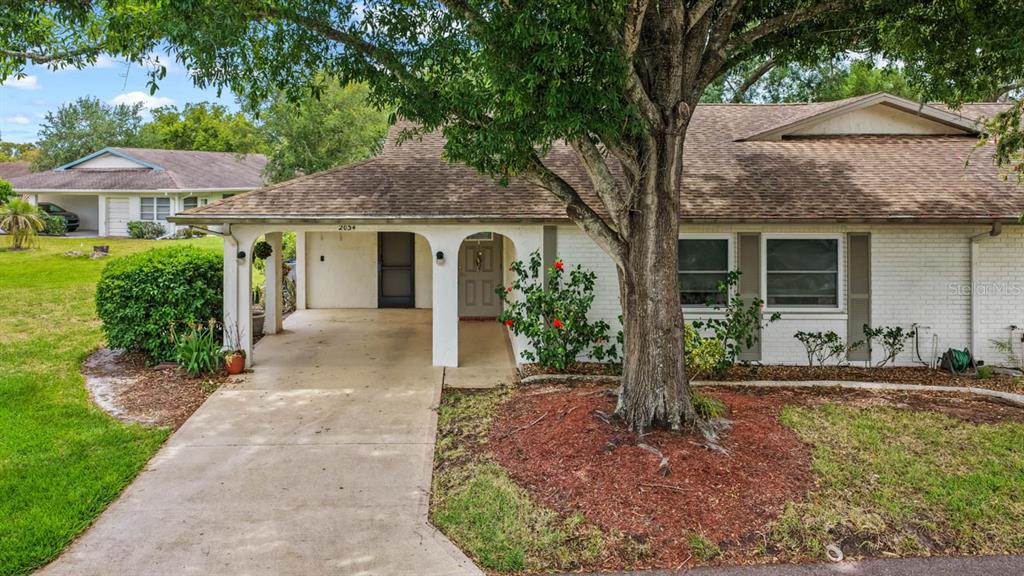 2034 Hawkhurst Circle, Unit 178 Sun City Center, FL 33573 - Photo 2 of 46 a front view of a house with garden