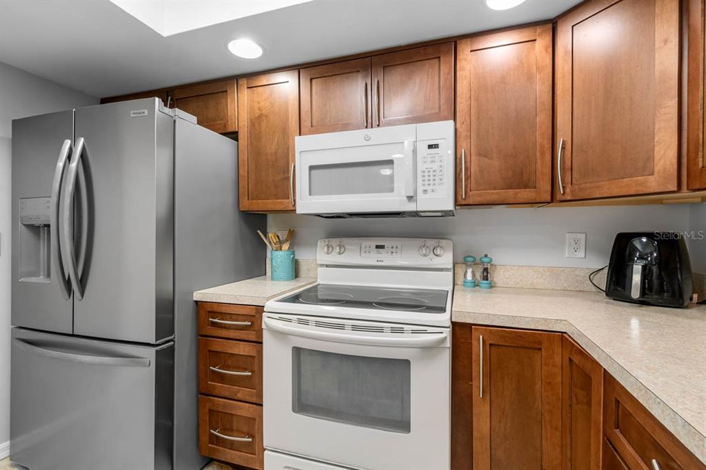 2034 Hawkhurst Circle, Unit 178 Sun City Center, FL 33573 - Photo 21 of 46 a kitchen with a refrigerator sink and cabinets