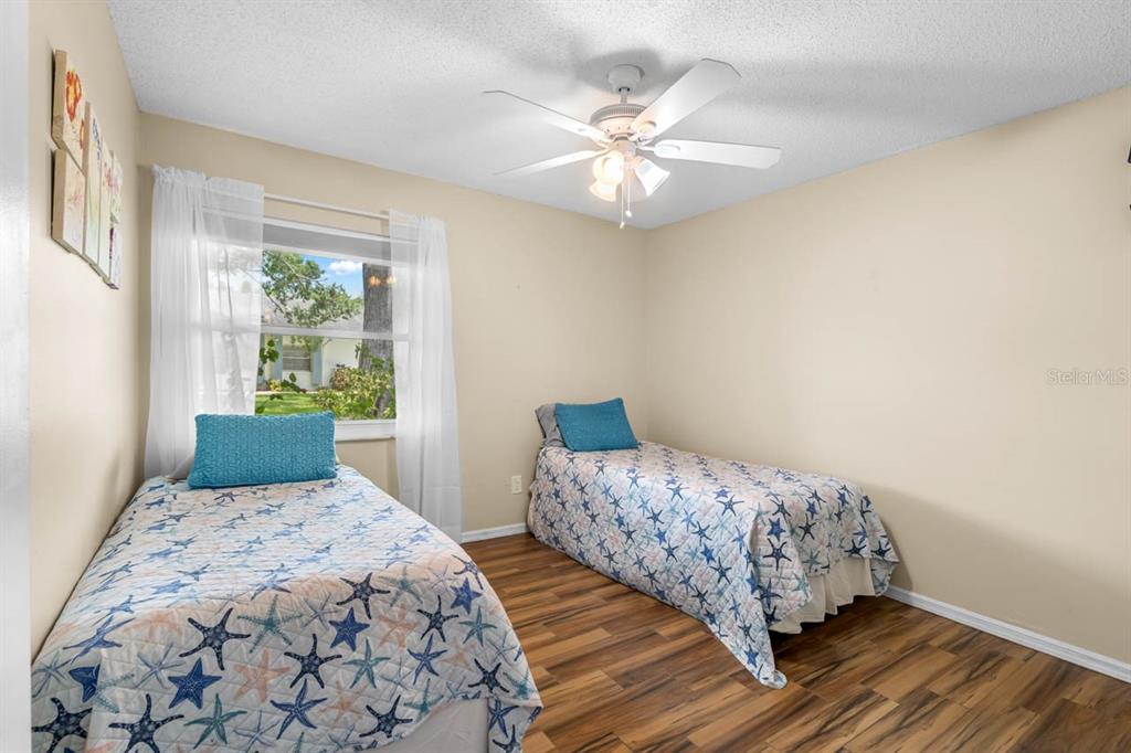 2034 Hawkhurst Circle, Unit 178 Sun City Center, FL 33573 - Photo 24 of 46 a bedroom with a bed and wooden floor