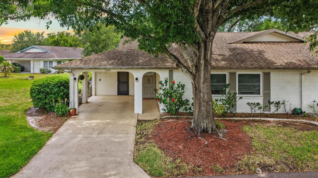 2034 Hawkhurst Circle, Unit 178 Sun City Center, FL 33573 - Photo 3 of 46 a front view of a house with garden