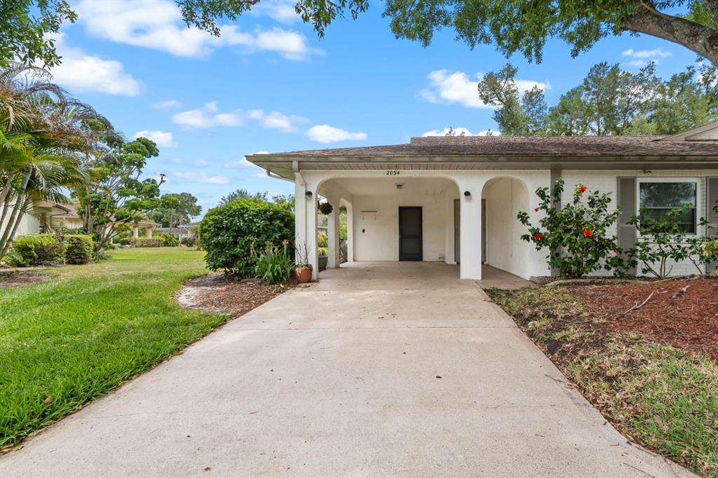 2034 Hawkhurst Circle, Unit 178 Sun City Center, FL 33573 - Photo 40 of 46 front view of a house with a garden