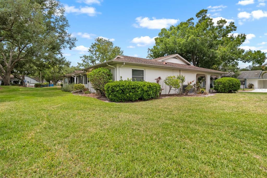 2034 Hawkhurst Circle, Unit 178 Sun City Center, FL 33573 - Photo 41 of 46 a view of a house with a big yard and potted plants and large trees
