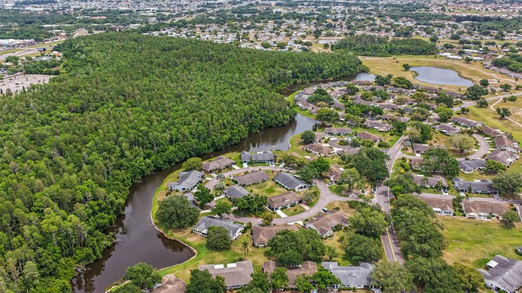 2034 Hawkhurst Circle, Unit 178 Sun City Center, FL 33573 - Photo 8 of 46 an aerial view of a house with a yard and lake view in back