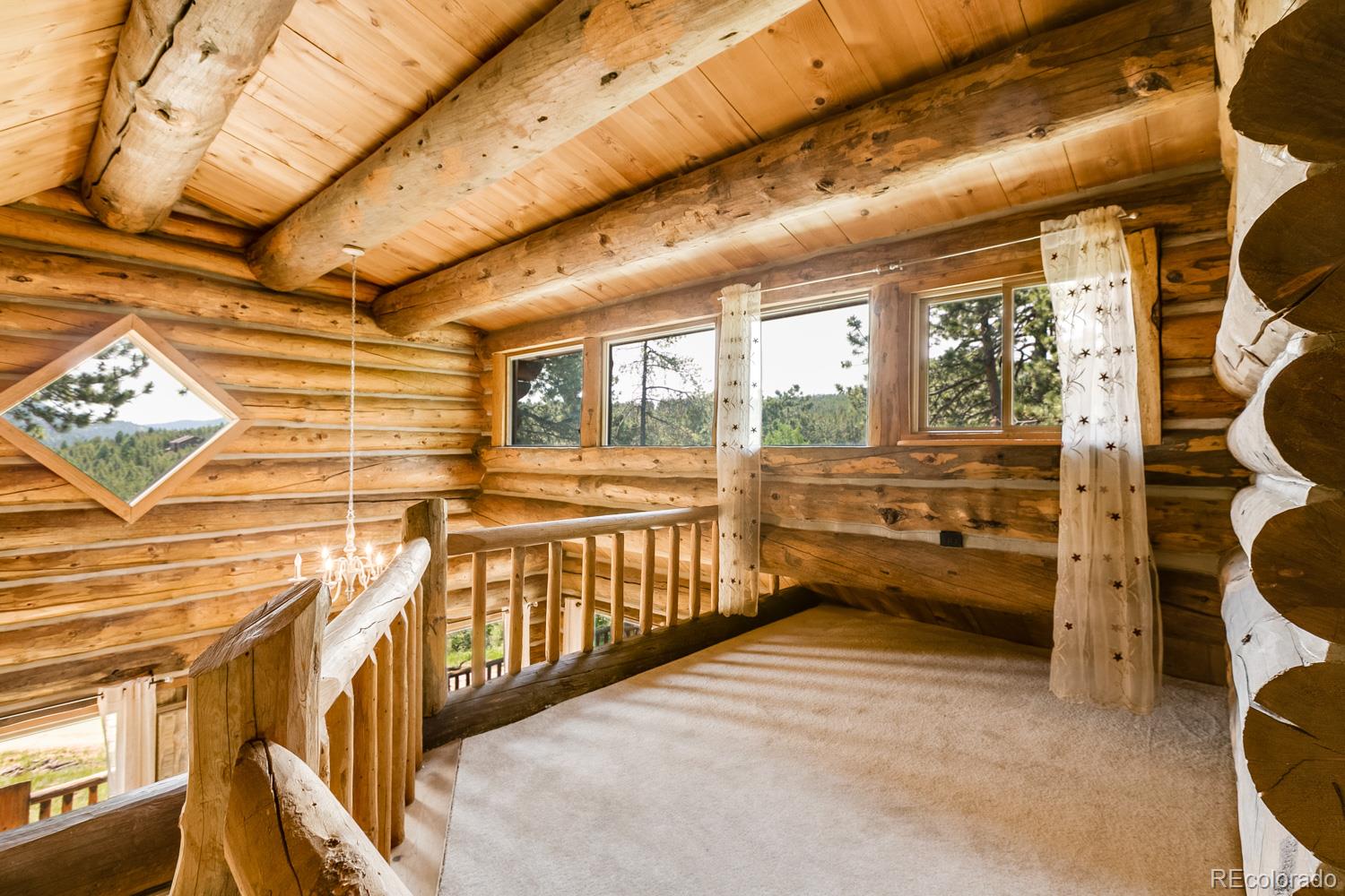 195 Pine Road Golden, CO 80403 - Photo 17 of 31 a view of a porch with wooden floor and iron stairs