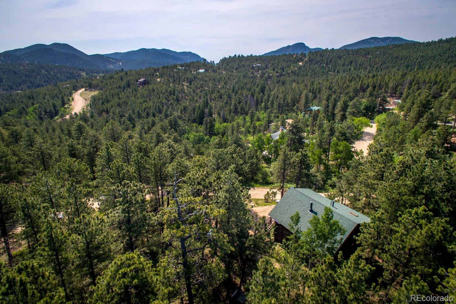 195 Pine Road Golden, CO 80403 - Photo 30 of 31 a view of a lush green hillside and a houses