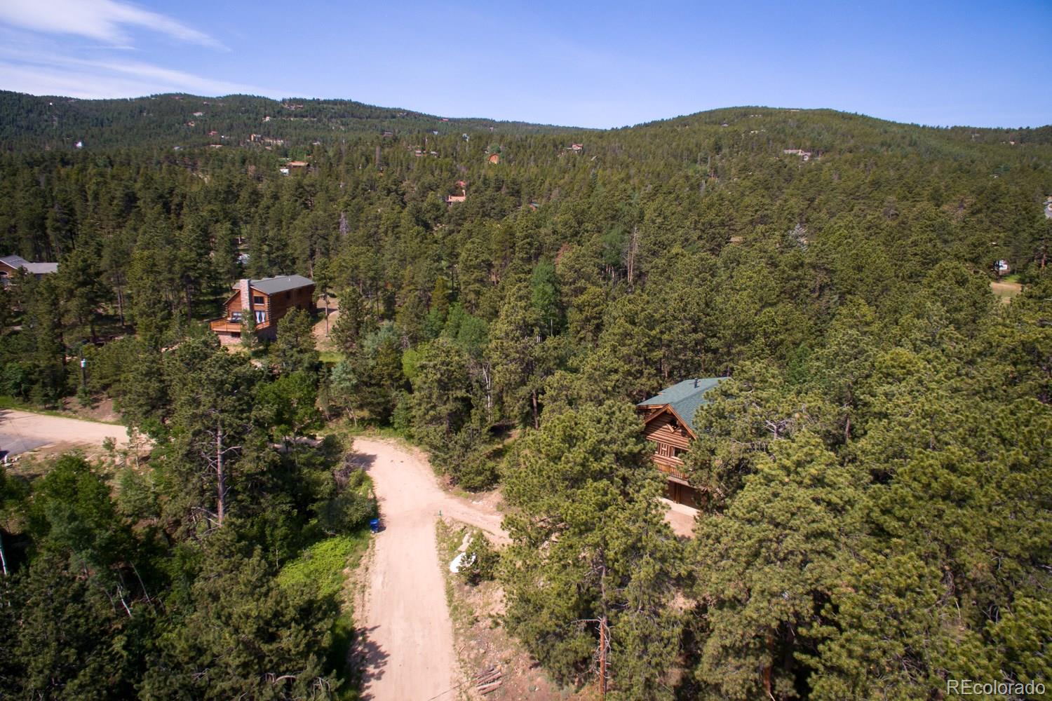 195 Pine Road Golden, CO 80403 - Photo 3 of 31 a view of a lush green hillside and a mountain